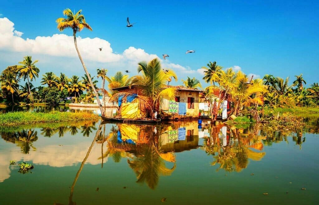 Serene Kerala backwaters with traditional house.