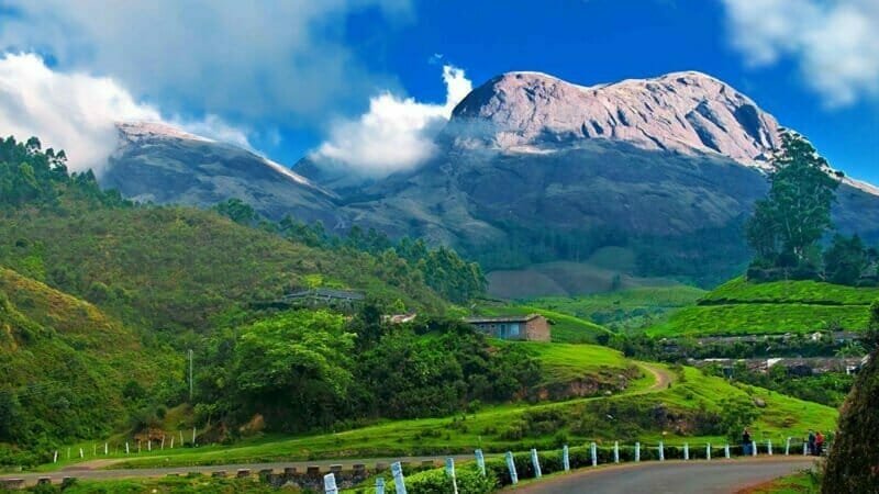 A breathtaking view of Devikulam Hills in Munnar, Kerala, surrounded by lush greenery.